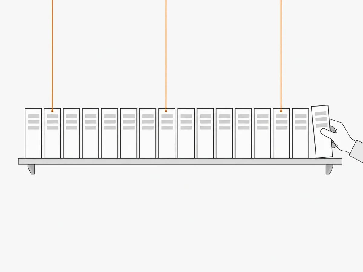 A long shelf of sixteen identical documents, three of them with a thin orange thread running up from the top, and a hand pulling out one of the documents that has no thread