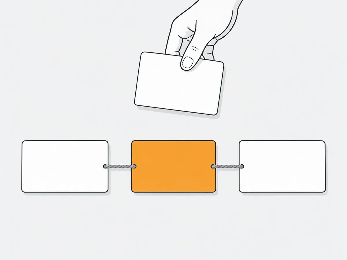 Three blank cards joined in a row by thread, the middle one orange, with a hand holding a fourth card above the row