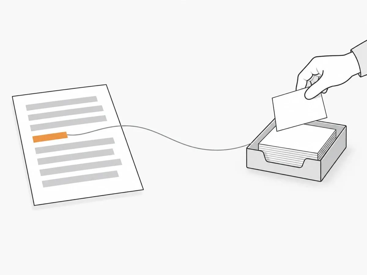 A thread running from an orange line on a printed article to a paper tray of blank cards, with a hand adding one more card